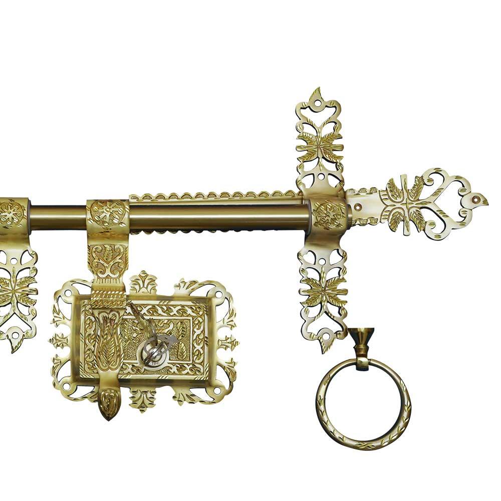 Decorative brass key with intricate designs on a white background
