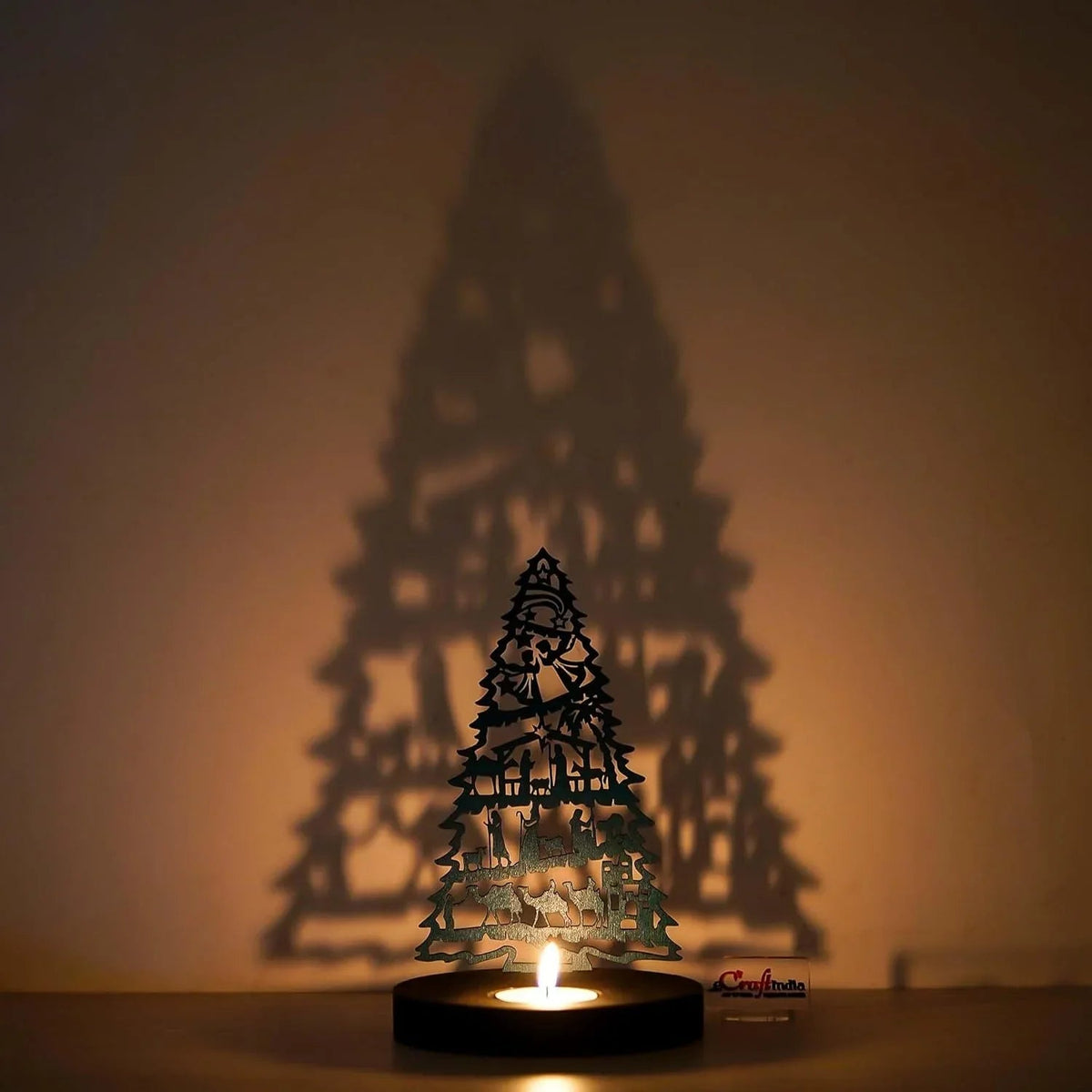 Decorative candle holder shaped like a Christmas tree with a warm glow on a beige background