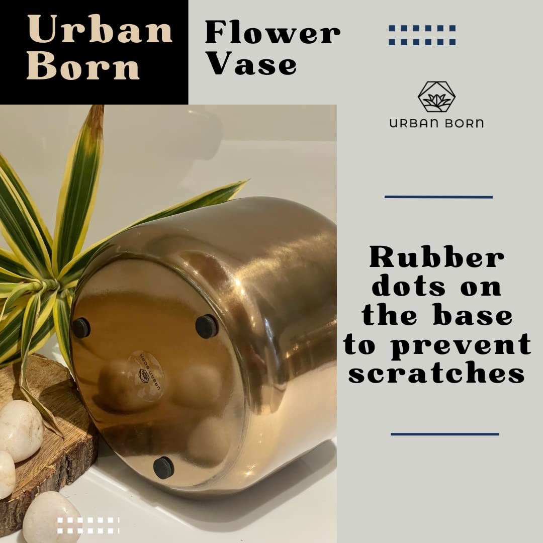 Gold flower vase with rubber dots on a white surface