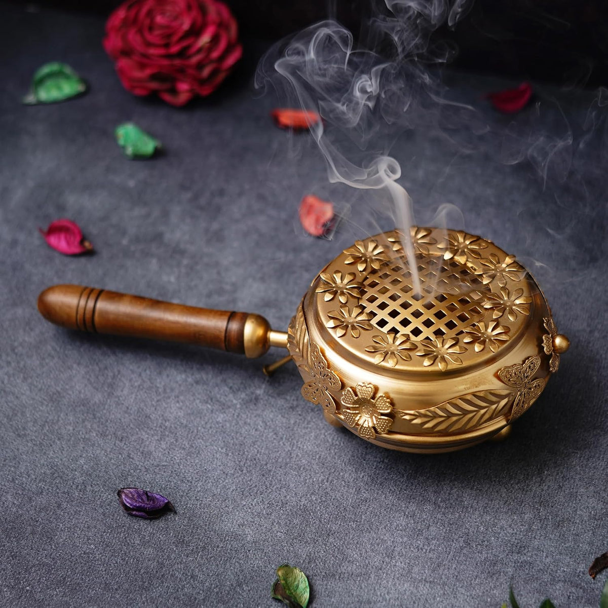 Decorative incense burner with smoke on a dark surface