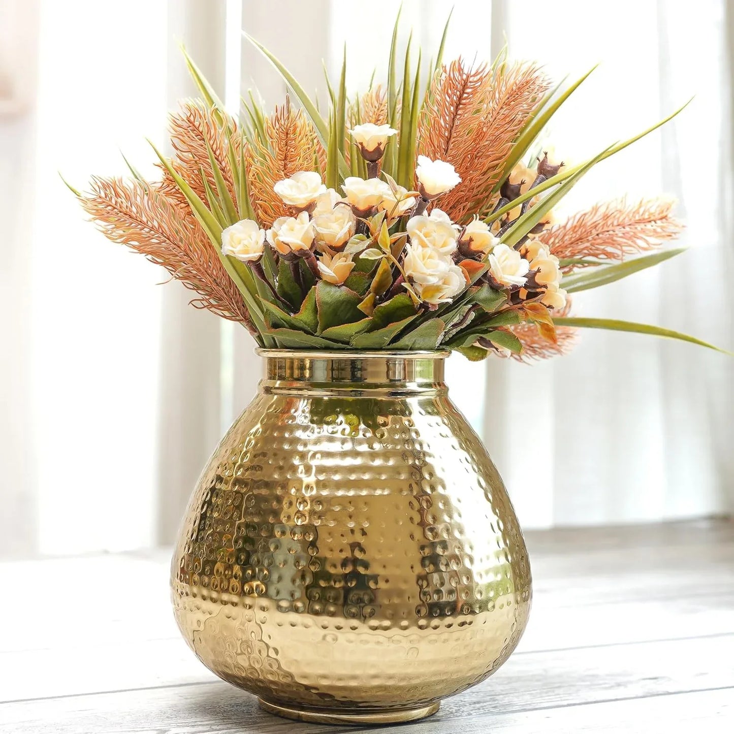 Gold vase with a bouquet of flowers