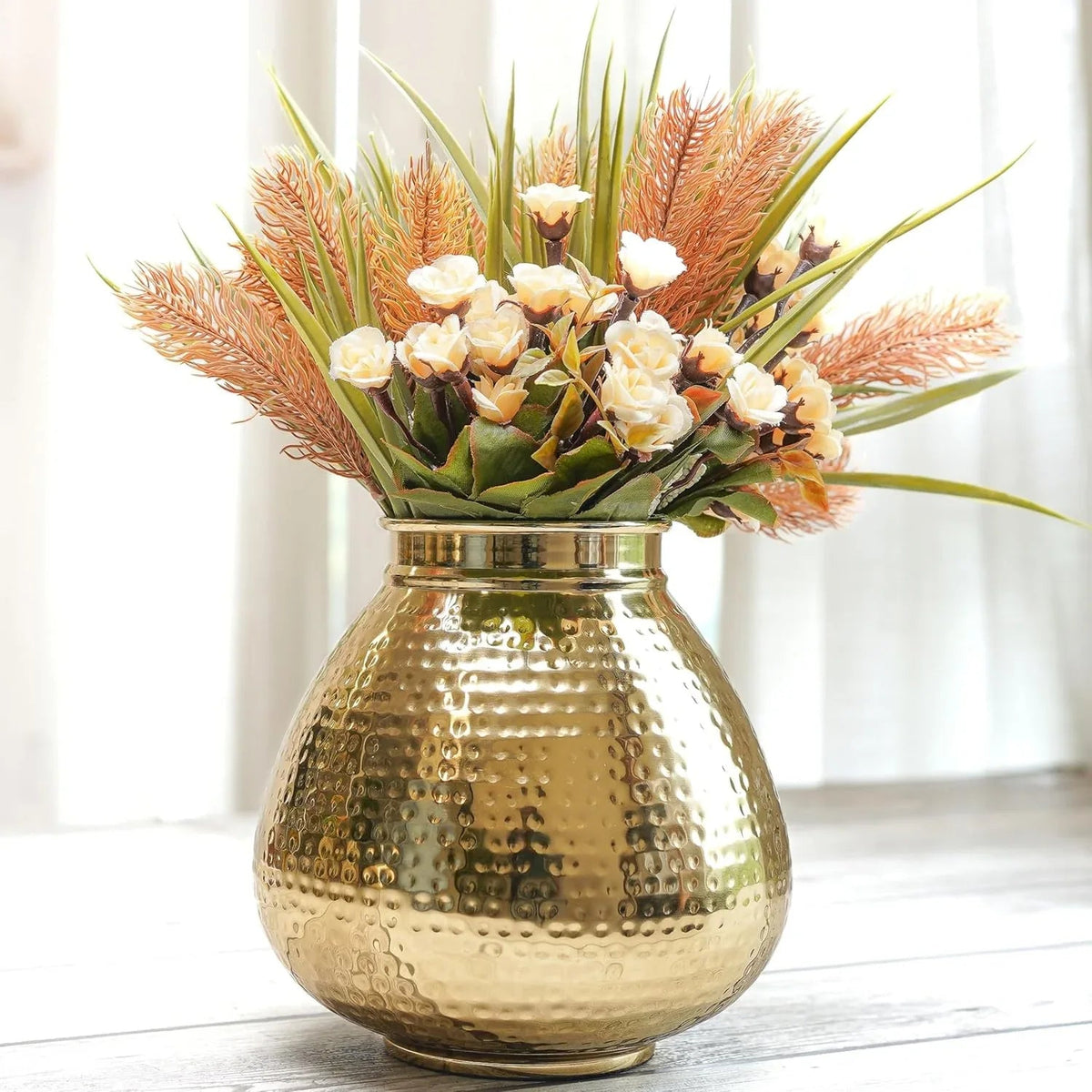 Gold vase with a bouquet of flowers