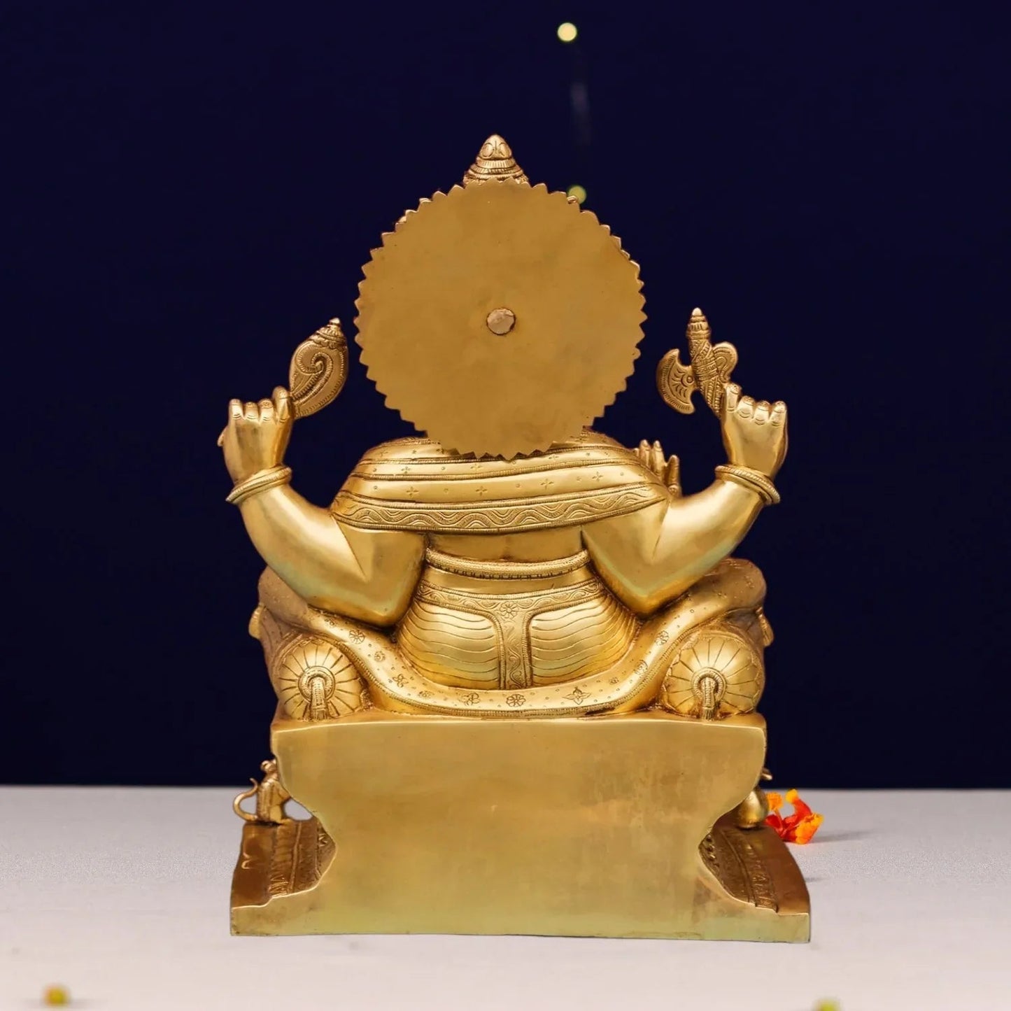 Handcrafted 9.8-inch solid brass Ganesha seated on ornate decorated throne — Maharaja Ganpati with four arms, sun-ray crown, Mooshika at base, warm antique gold finish — ArtyCraftz
