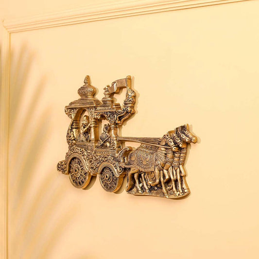 Decorative gold chariot with horses on a beige background