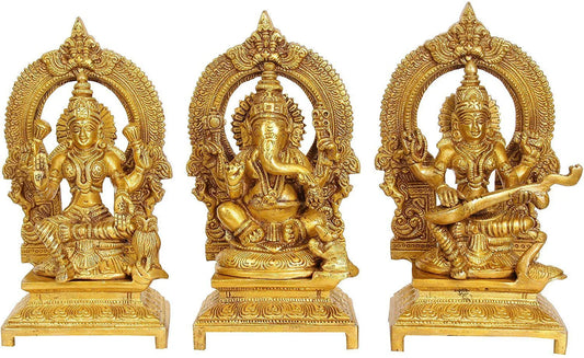 Set of 3 handcrafted 7-inch solid brass Lakshmi, Ganesha and Saraswati idols each with ornate prabhavali arch and engraved footed base — antique gold finish temple trio — ArtyCraftz