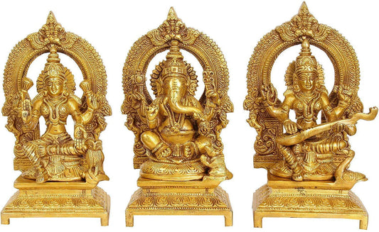 Set of 3 handcrafted 7-inch solid brass Lakshmi, Ganesha and Saraswati idols each with ornate prabhavali arch and engraved footed base — antique gold finish temple trio — ArtyCraftz