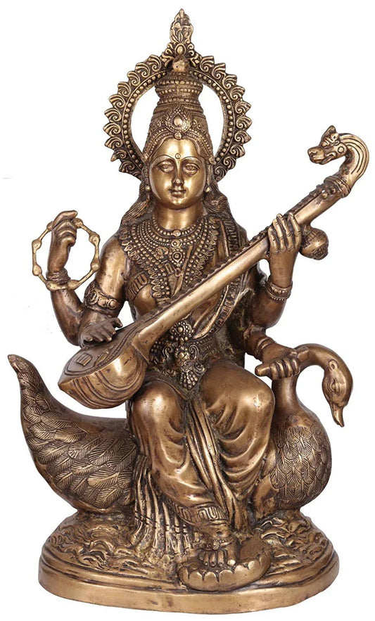 Brass Goddess Saraswati with Veena Siting on Swan Statue
- ArtyCraftz.com