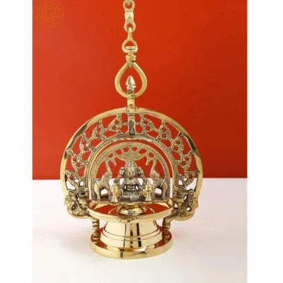 Decorative brass lamp with intricate design on a white background