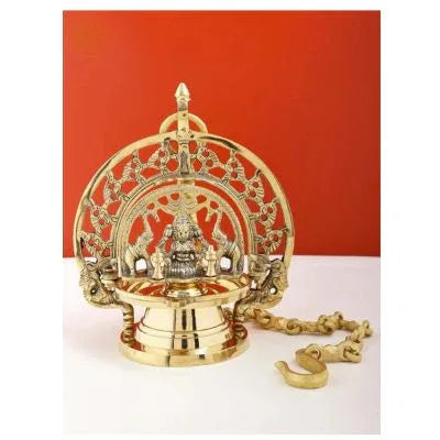 Decorative brass lamp with intricate design on a white background