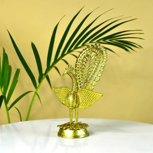 Gold peacock decorative item on a white surface with a yellow background