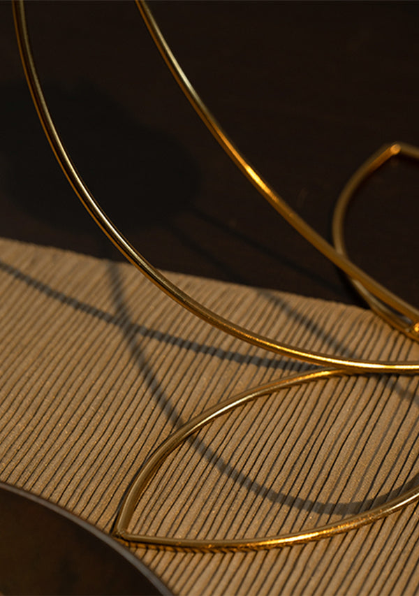 Gold hoop earring on a textured surface