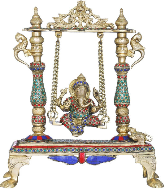 Handcrafted 13-inch solid brass Ganesha on swing Jhula idol — turquoise, coral and lapis stone-studded pillars, brass chain suspension, peacock finials, elephant feet base — ArtyCraftz