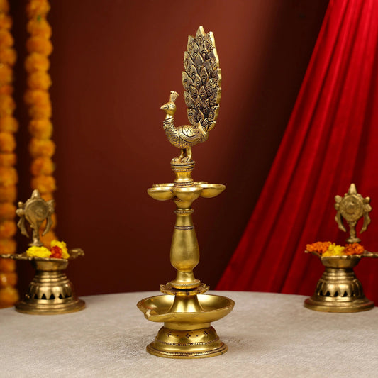 Decorative brass lamp with peacock design on a red and brown background