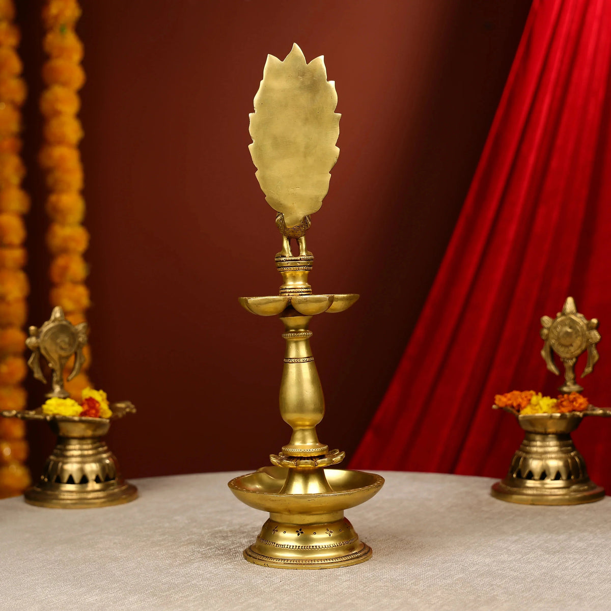 Brass lamp with decorative elements on a red and brown background