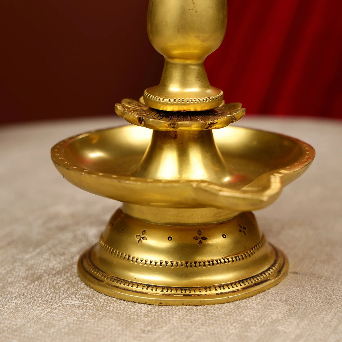 Brass lamp with intricate designs on a textured surface