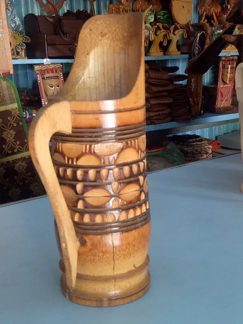 Wooden vase with decorative patterns on a blue surface