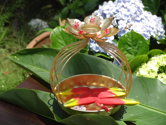 Inside the bowl float colorful lotus-shaped candles and scattered rose petals.