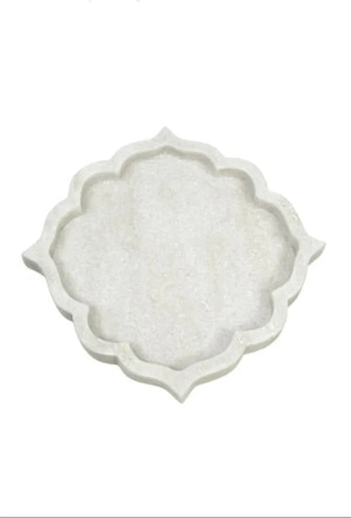 Decorative white plate with scalloped edge on a white background