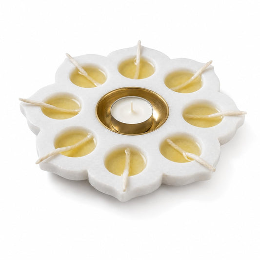 White marble flower-shaped candle holder with eight outer wells and a central brass-finish cup-artycraftz.com