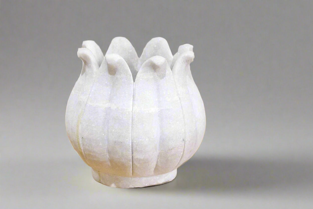 White ceramic vase with bird-like shapes on a gray background