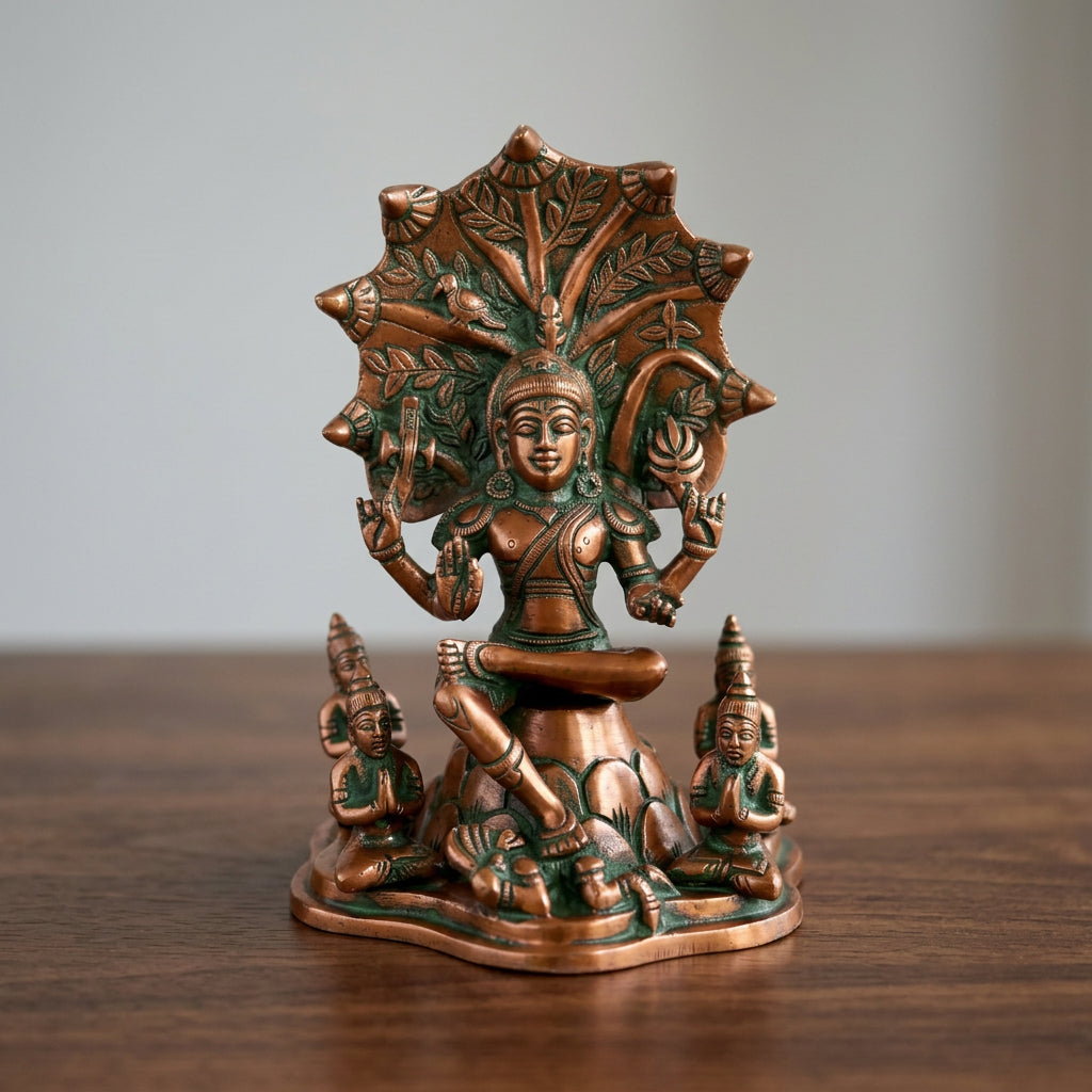 Brass Dakshinamurti statue seated beneath an ornate tree-inspired backdrop with detailed sculpting-artycraftz.com