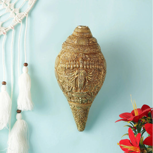 Decorative gold wall hanging with intricate designs on a light blue background