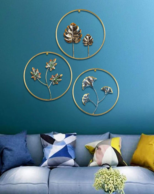 Decorative wall art with floral designs on a blue wall above a sofa with colorful cushions.