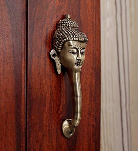 Brass Buddha head door handle on a wooden door