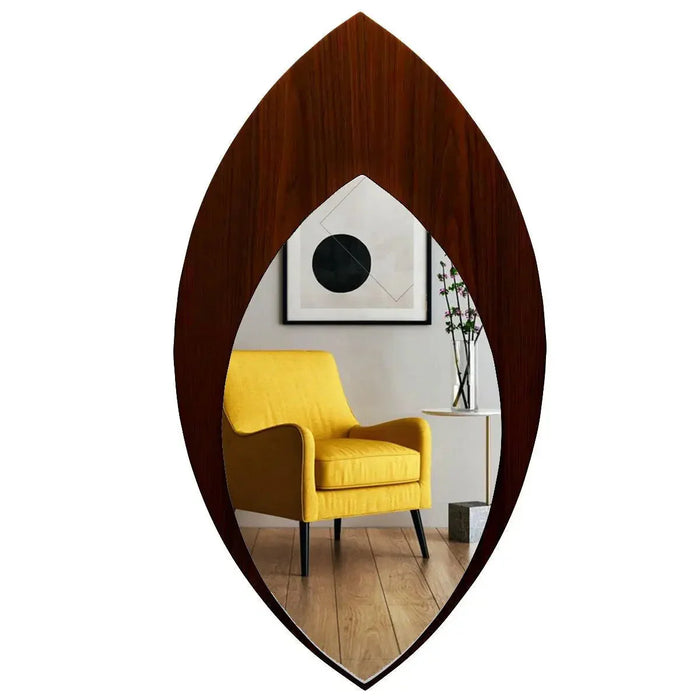 Wooden wall mirror reflecting a yellow armchair and a white wall