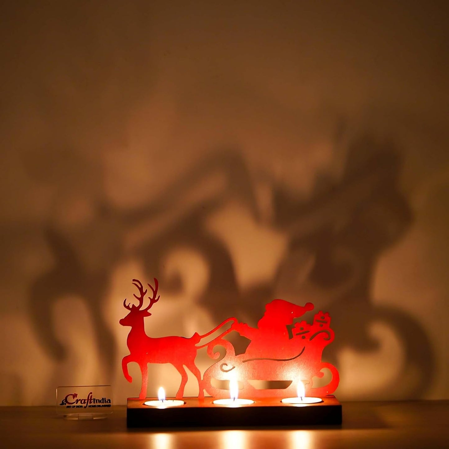 Red laser cut silhouette of Santa and reindeer with candles