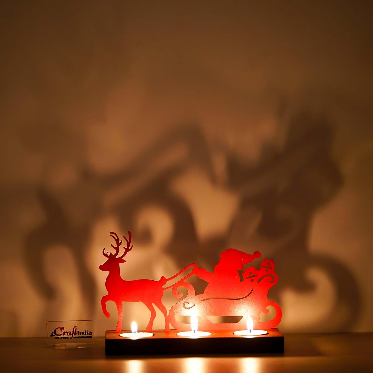 Red laser cut silhouette of Santa and reindeer with candles