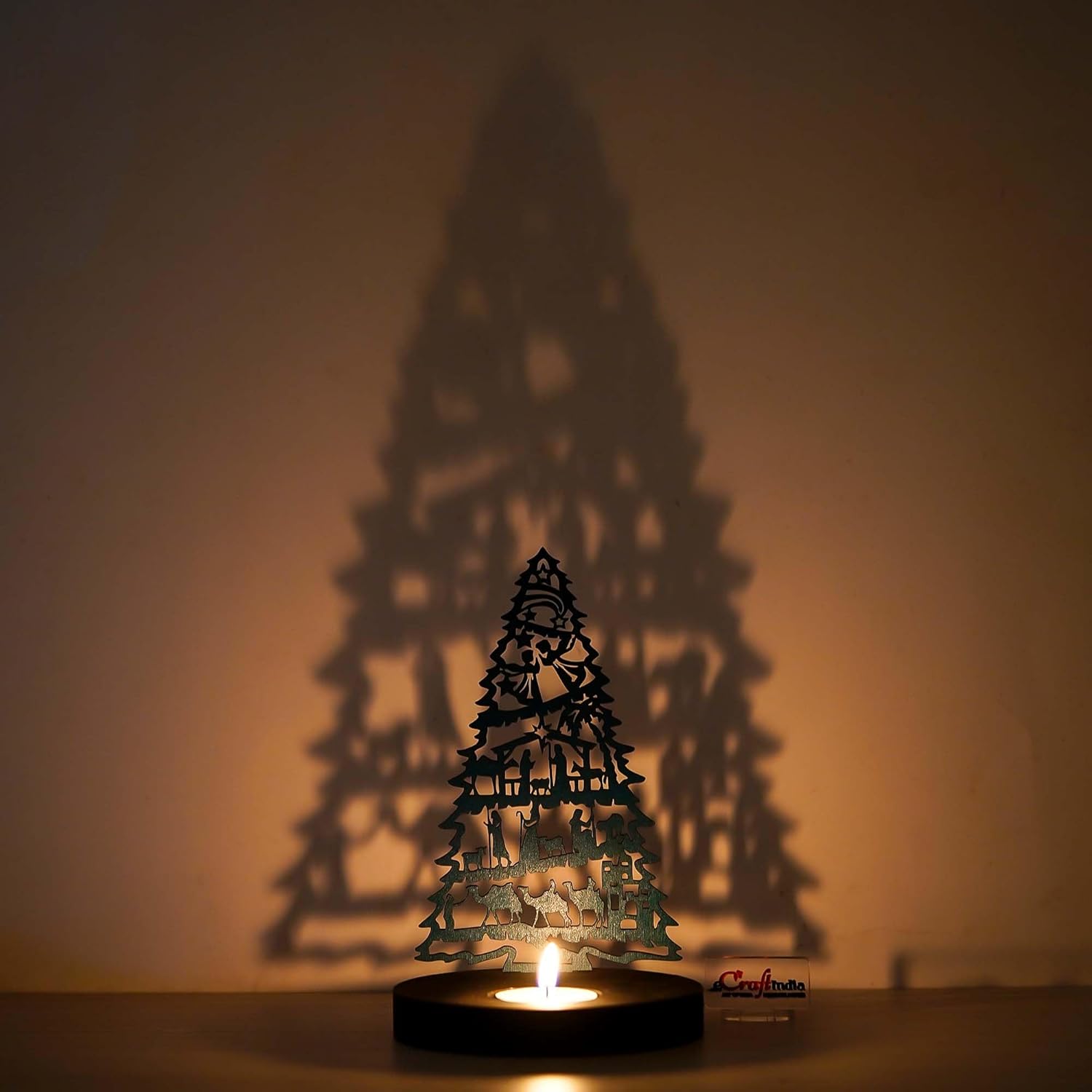 Decorative candle holder shaped like a Christmas tree with a warm glow on a beige background