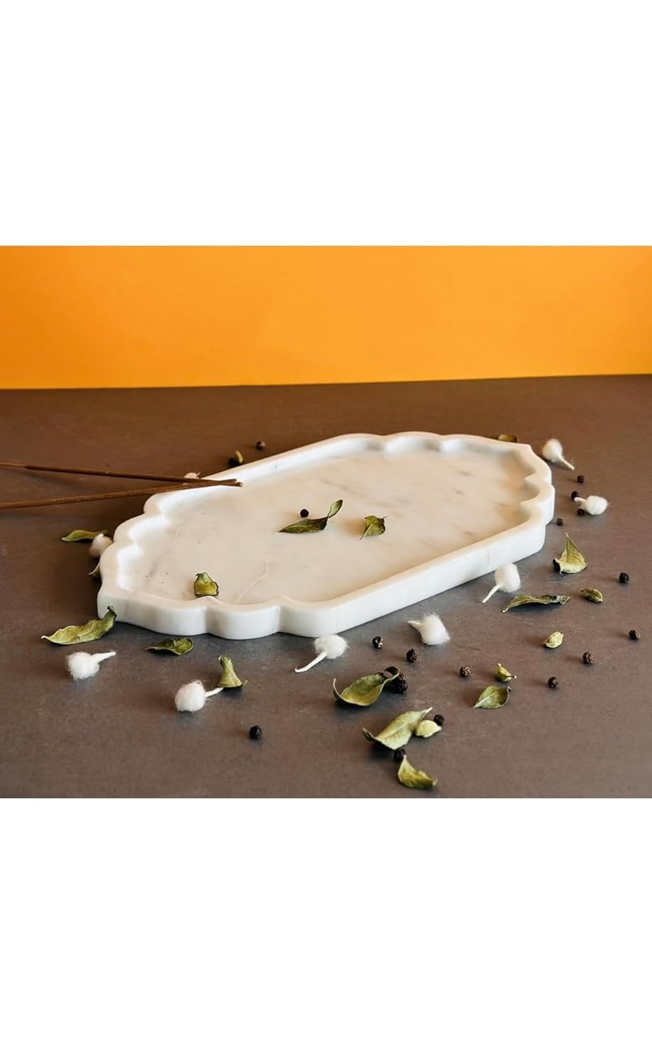 White decorative tray with small green leaves and white flowers