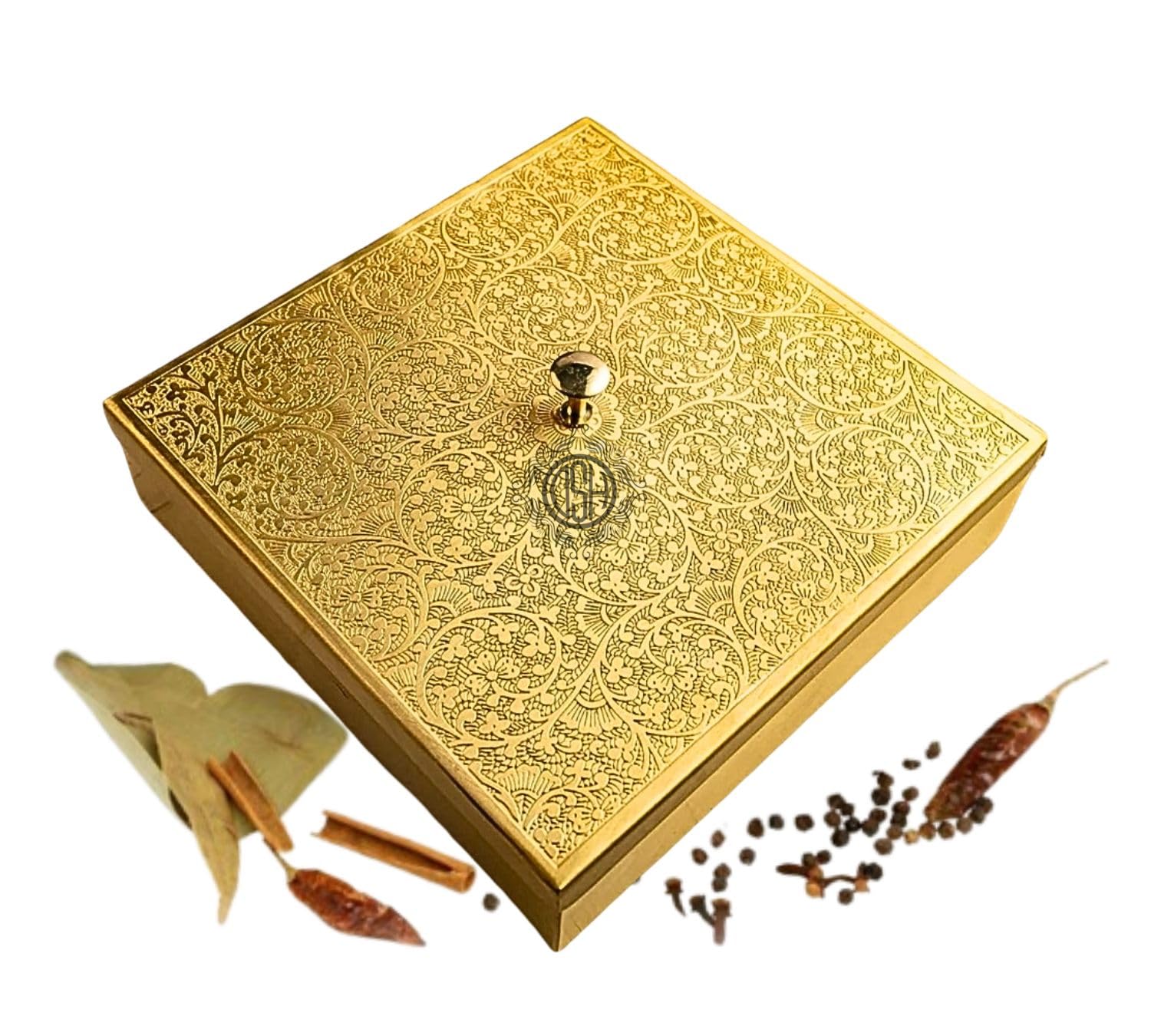 Decorative gold box with intricate patterns, accompanied by small spices
