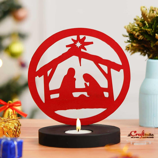 Red nativity scene candle holder on a wooden surface