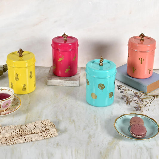 Set of colorful metal jars with decorative lids on a marble surface