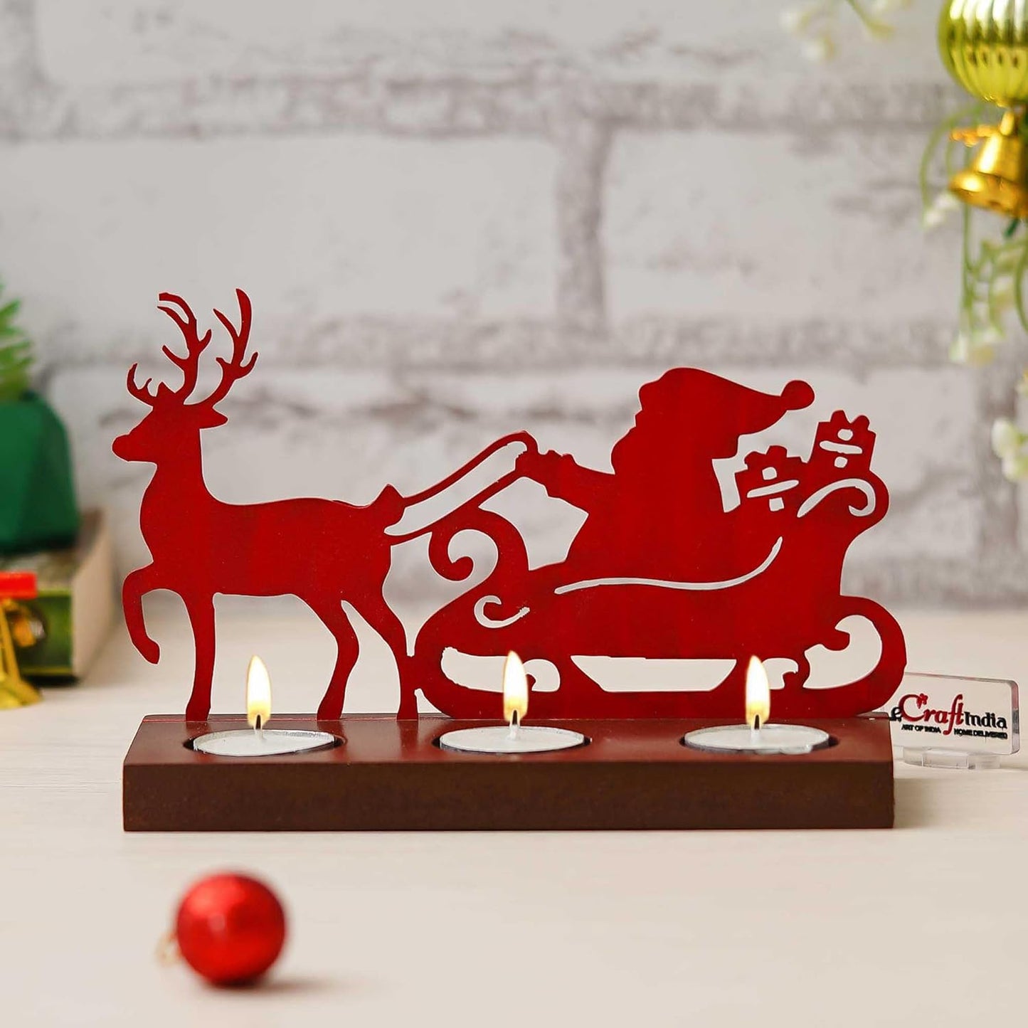 Decorative candle holder with Santa Claus, reindeer, and sleigh design