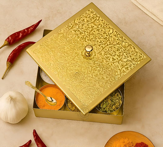 Decorative gold box with spices and a spoon