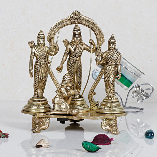 A brass statue of Lord Rama, Goddess Sita, Lord Lakshmana, and Lord Hanuman, symbolizing the Ram Darbar, placed on a decorative stand.