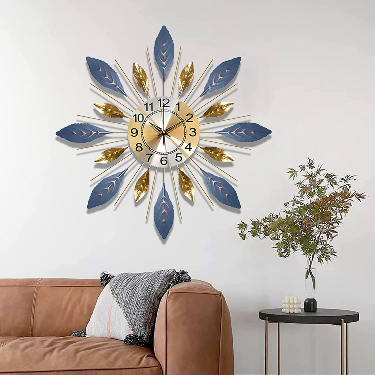 Decorative wall clock with blue and gold feathers on a white wall above a brown sofa.
