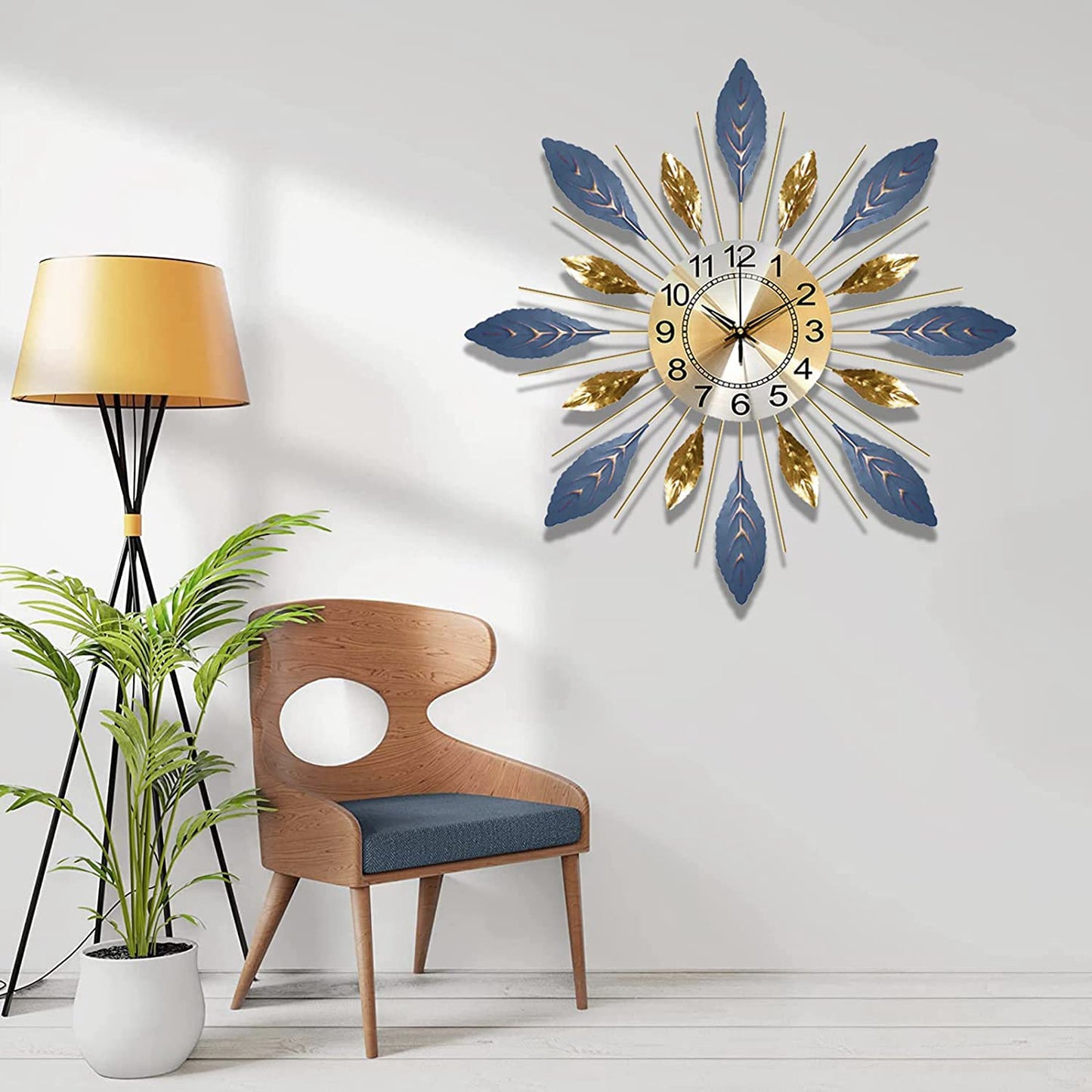 Decorative wall clock with blue and gold feathers in a room with a chair, lamp, and plant.