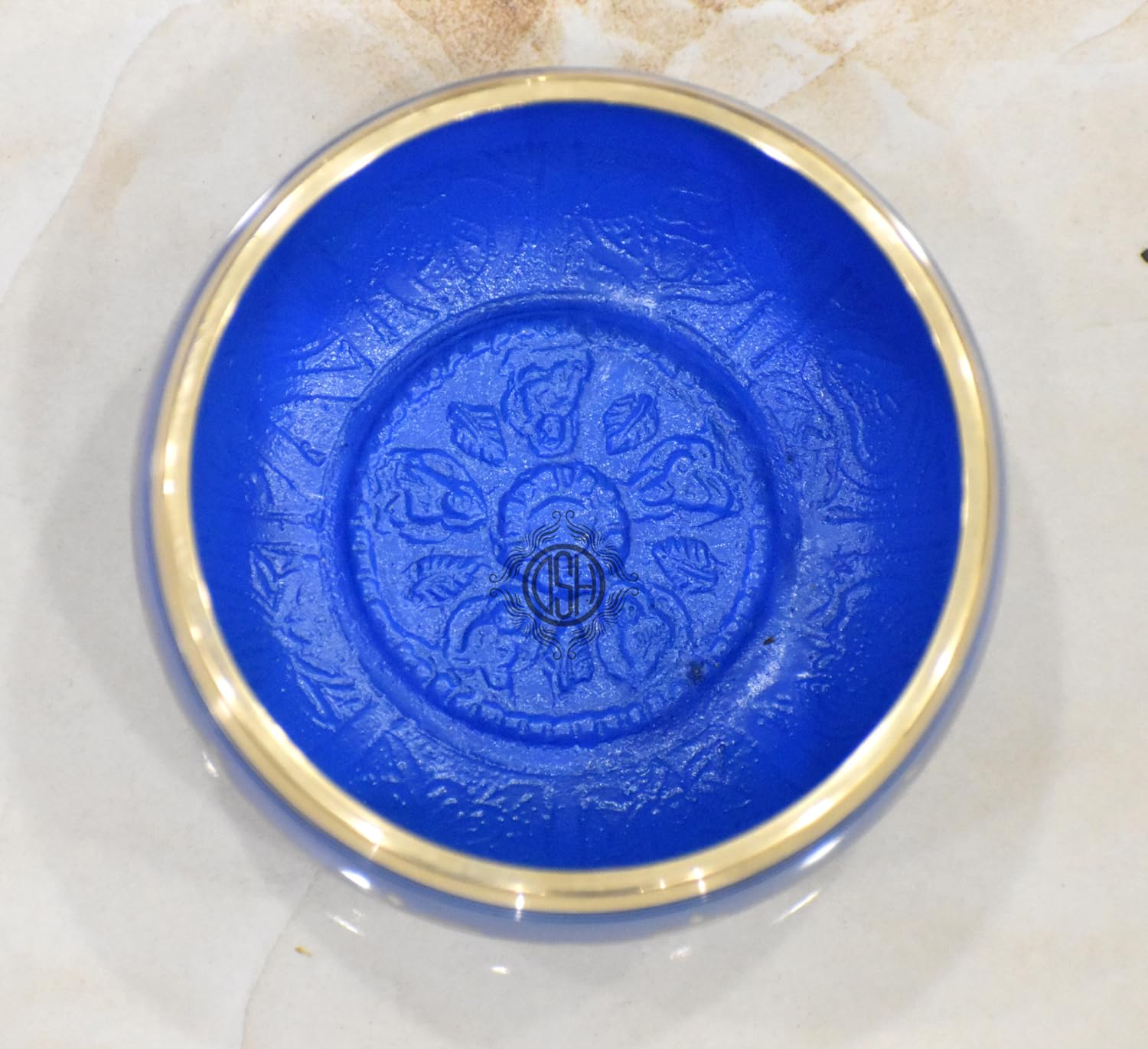 Blue dish with gold rim on a marble surface