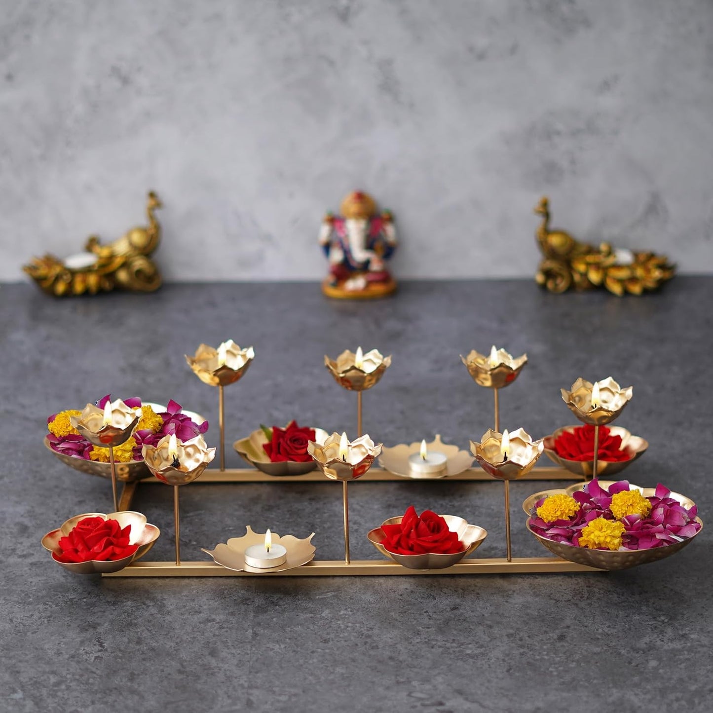 Decorative metal stand with lotus-shaped holders and candles