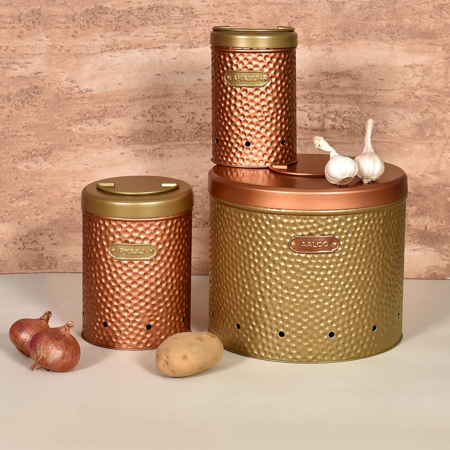Set of copper canisters with gold lids on a wooden surface