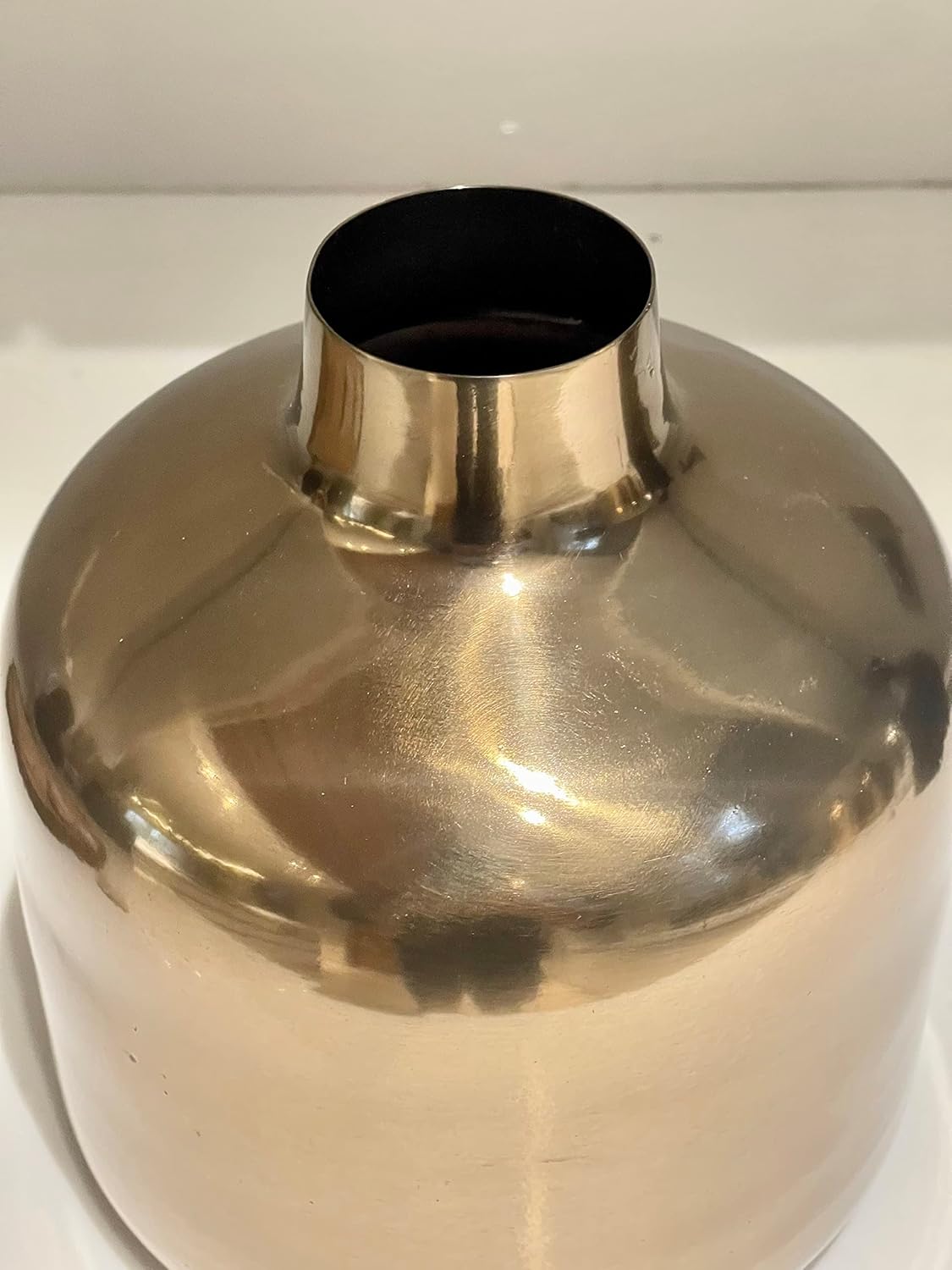 Golden colour metallic vase on a white background