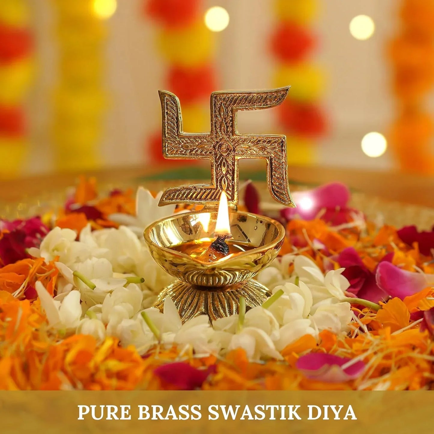 Pure brass swastik diya with a flame on a bed of flowers
