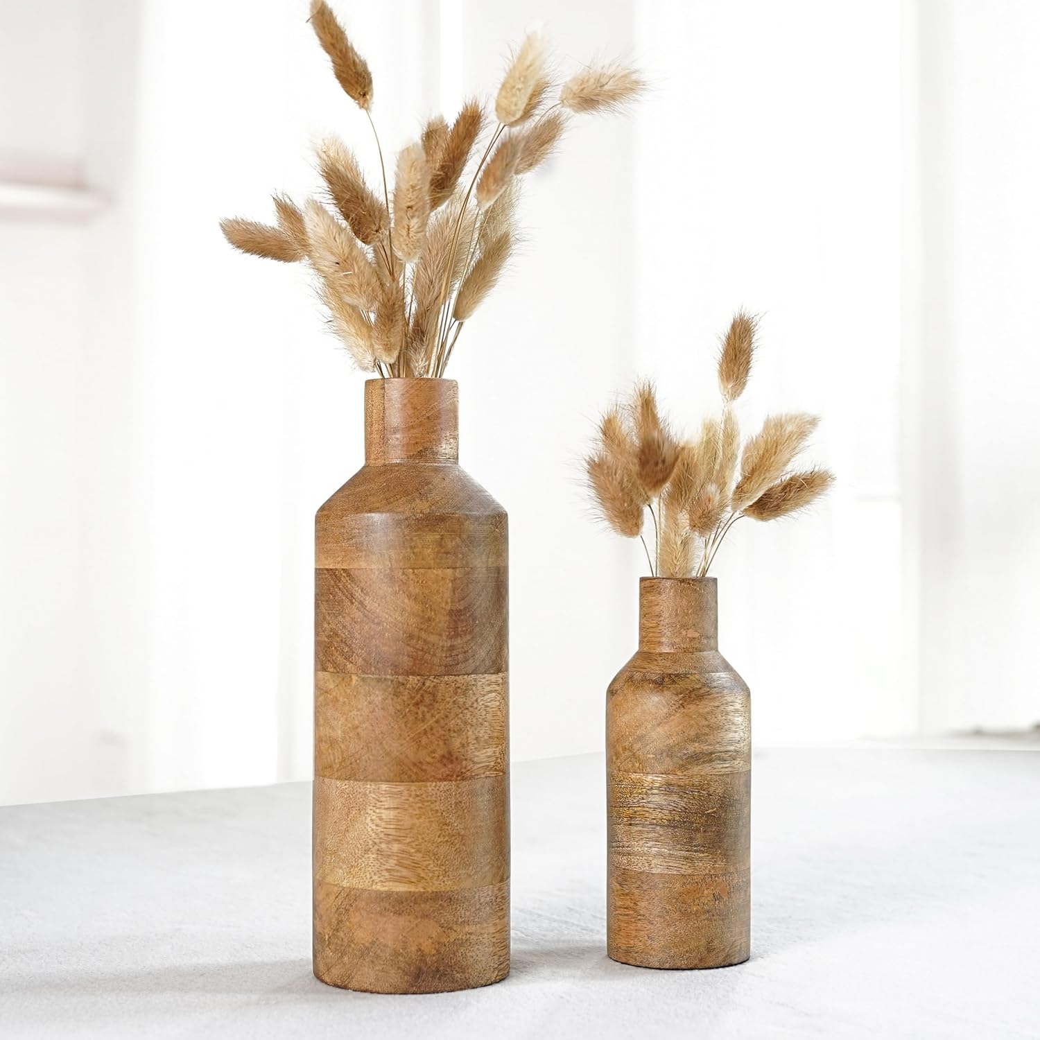 Two wooden vases with dried pampas grass