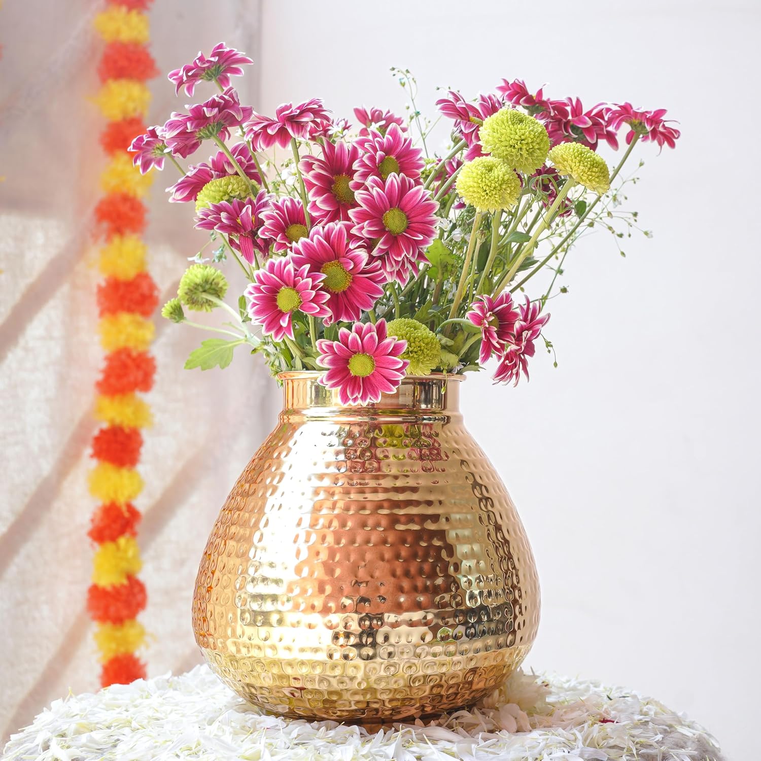 Gold vase with pink and green flowers