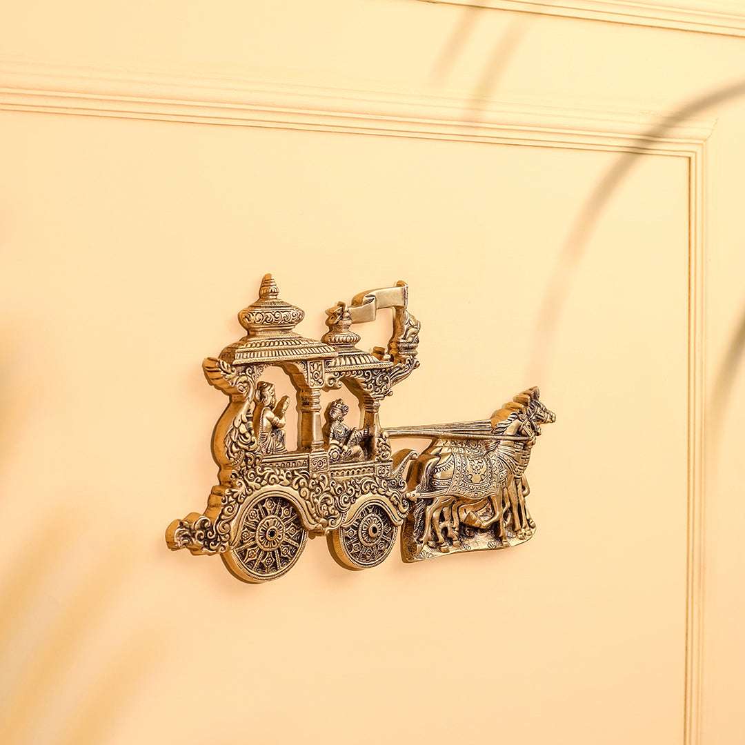 Decorative gold chariot figurine on a beige background