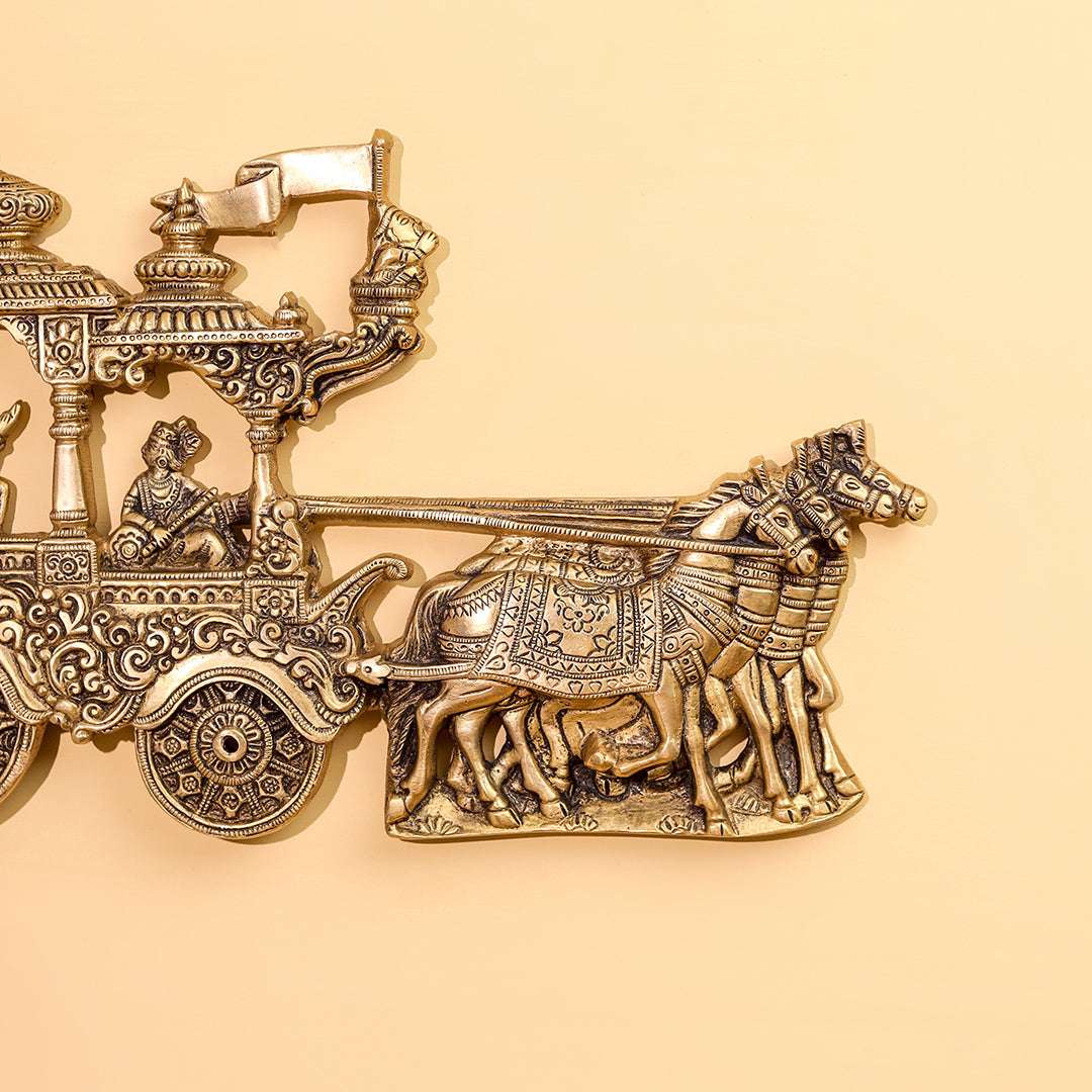 Decorative brass chariot with horses on a beige background